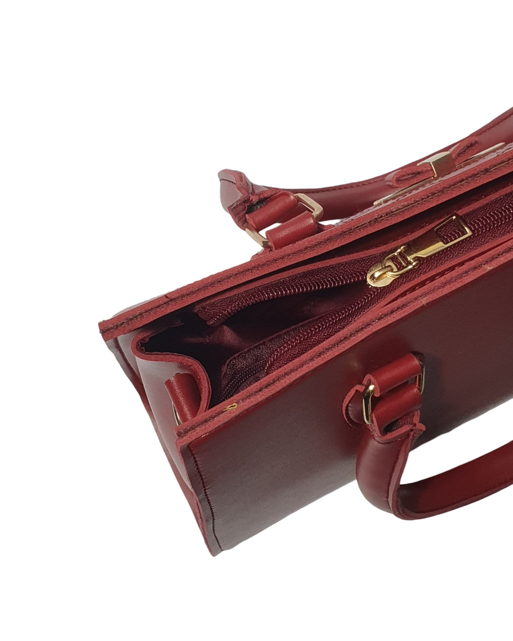 an image showing zipline of a red quilted top handle bag with gold accents and red sturdy handles.