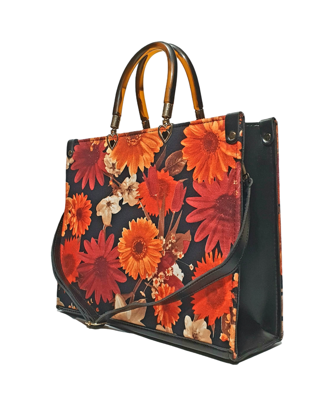 floral tote bag with red and orange flowers on a black background, featuring a tortoise top handle and black shoulder strap.